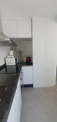 a kitchen with white cabinets and a counter top at Habitaciones VIP en Vivienda Compartida, Muy Céntricas, Ruzafa Centro, Bonitas y Tranquilas in Valencia