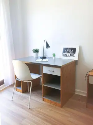 a desk with a white chair and a desk with a lamp at MiCampus Burjassot 1 Student Residence in Burjasot