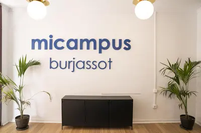 a sign in a room with two plants at MiCampus Burjassot 1 Student Residence in Burjasot