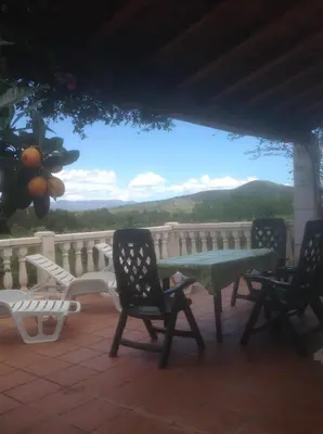 a table and chairs on a porch with a view at Casa Ramona in Valencia