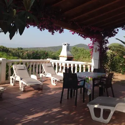 a patio with a table and chairs and a white fence at Casa Ramona in Valencia