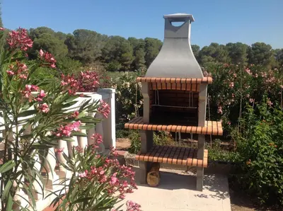 a bird feeder sitting on a bench in a garden at Casa Ramona in Valencia