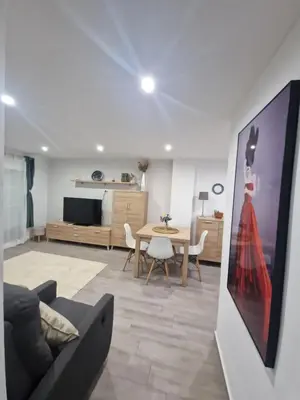 a living room with a couch and a table at Relax Zone Cullera Parking fee en edificio in Cullera