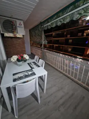 a white table and chairs on a balcony at Relax Zone Cullera Parking fee en edificio in Cullera