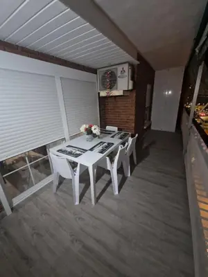 a white table and chairs on a balcony at Relax Zone Cullera Parking fee en edificio in Cullera