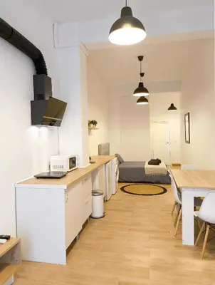 a living room with a kitchen and a dining room at Central Cozy Ground Floor Studio in Valencia