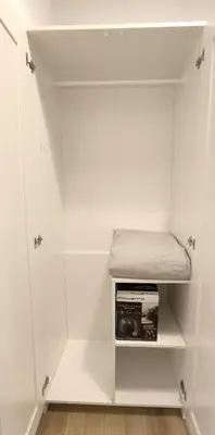 a white closet with a shelf and a microwave at Central Cozy Ground Floor Studio in Valencia