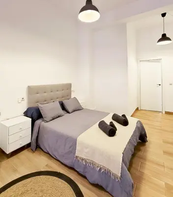 a bedroom with a bed with two pillows on it at Central Cozy Ground Floor Studio in Valencia