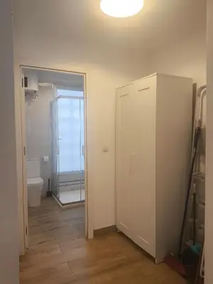 a bathroom with a closet and a toilet and a door at Central Cozy Ground Floor Studio in Valencia