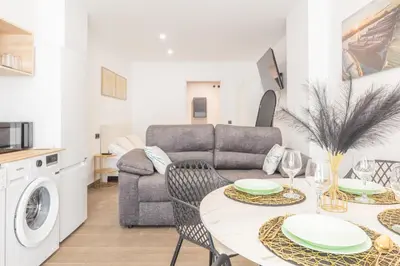 a living room with a table and a couch at Loft Urban Beach - Cerca del Mar in Valencia