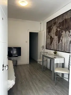 a bedroom with a large white bed and a bathroom at apartamento livia in Valencia