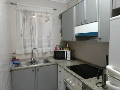 a small kitchen with a sink and a microwave at apartamento livia in Valencia