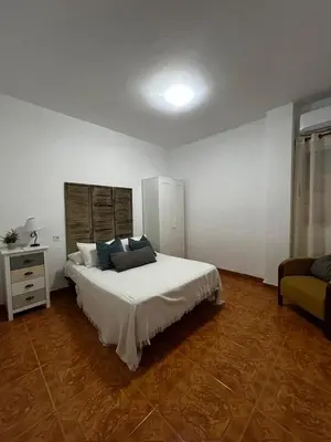 a room with a table and chairs and a television at apartamento livia in Valencia