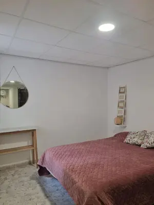 a bedroom with a bed and a table with a mirror at Rural studio in Cortez de Pallas