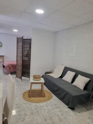 a living room with a couch and a table at Rural studio in Cortez de Pallas