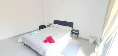 a bedroom with a white bed with two stuffed animals on it at Céntricas, Tranquilas y Acogedoras Habitaciones de Matrimonio en Vivienda Compartida in Valencia