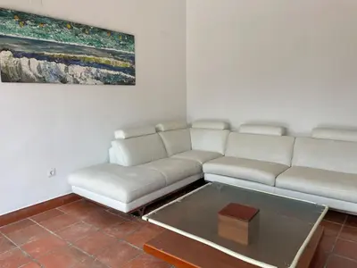 a living room with a white couch and a coffee table at Villa con barbacoa para familias in Mareny Blau