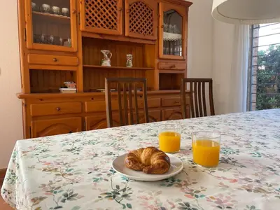 a plate of croissants on a table with two glasses of orange juice at Villa con barbacoa para familias in Mareny Blau