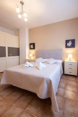 a bedroom with a large bed with towels on it at Casa Potelos by Concept Flats in Navajas