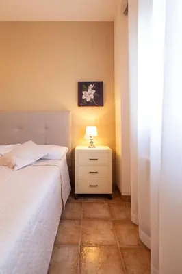 a bedroom with two beds and a lamp on a night stand at Casa Potelos by Concept Flats in Navajas
