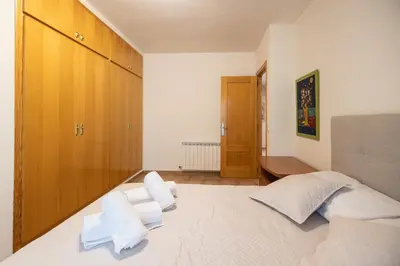 a bedroom with a large bed with white pillows at Casa Potelos by Concept Flats in Navajas