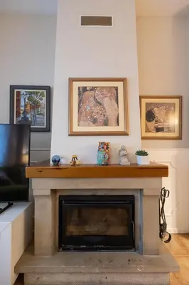 a living room with a fireplace and a tv at Casa Potelos by Concept Flats in Navajas