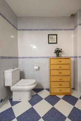 a bathroom with a toilet and a yellow dresser at Casa Potelos by Concept Flats in Navajas