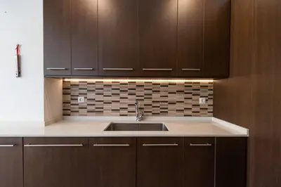 a kitchen with wooden cabinets and a sink at Casa Potelos by Concept Flats in Navajas