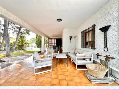 a living room with white furniture on a wooden floor at Villa El Plantio in Pla del Pou