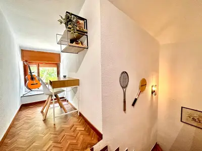 a room with a desk and a tennis racket on the wall at Villa El Plantio in Pla del Pou