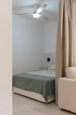 a bedroom with a bed and a ceiling fan at GuestReady - Reental Apartments in Valencia