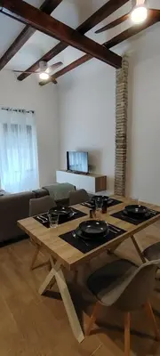 a wooden table in a living room with a couch at Beachside apartment in Valencia