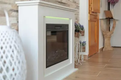 a living room with a fireplace with a tv at Apartamento Estilo Rustico Buñol - ELPATIO- in Buñol