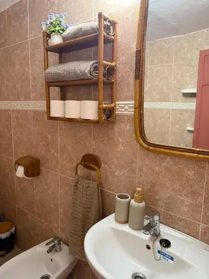 a bathroom with a sink and a mirror and towels at Casita con vistas al Castillo de Cullera in Cullera
