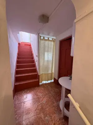 a staircase in a room with a red stair case at Casita con vistas al Castillo de Cullera in Cullera
