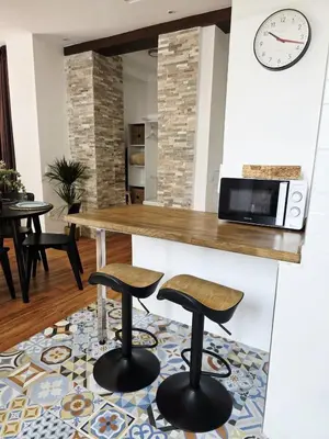 a kitchen with a counter and two stools at La Marina de Coup de Coeur Appartments in Valencia