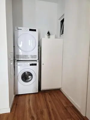 a kitchen with a washing machine and a refrigerator at La Marina de Coup de Coeur Appartments in Valencia