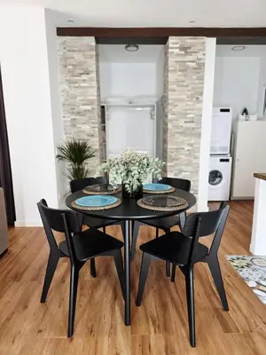 a dining room with a black table and chairs at La Marina de Coup de Coeur Appartments in Valencia