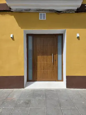 a building with a wooden door on the side of it at La Marina de Coup de Coeur Appartments in Valencia