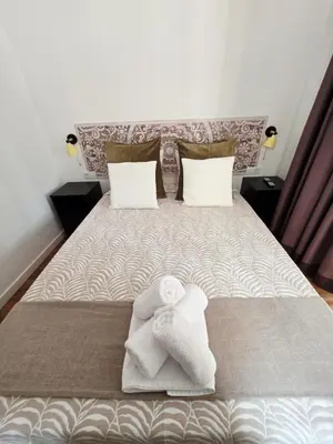 a bedroom with a bed with towels on it at La Marina de Coup de Coeur Appartments in Valencia