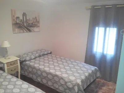 a bedroom with two twin beds and a window at Ca'l Suecà in Chella