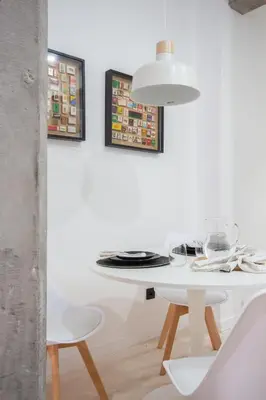 a white dining room with a white table and chairs at Manya Valencia by Concept Flats in Valencia