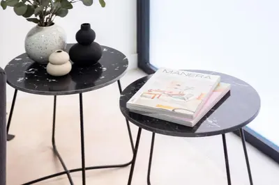 two black tables with books and a vase on them at Manya Valencia by Concept Flats in Valencia