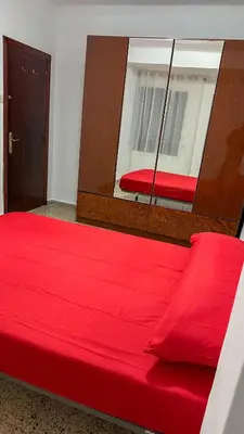 a red bed in a room with a window at Kmilo in Valencia