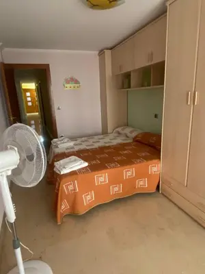 a bedroom with a bed and a fan at Casa Flare Apartmento para 6 personas en Cheste in Cheste