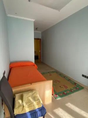 a small bedroom with a bed and a rug at Casa Flare Apartmento para 6 personas en Cheste in Cheste