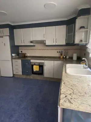 a kitchen with white cabinets and a sink at Casa Flare Apartmento para 6 personas en Cheste in Cheste