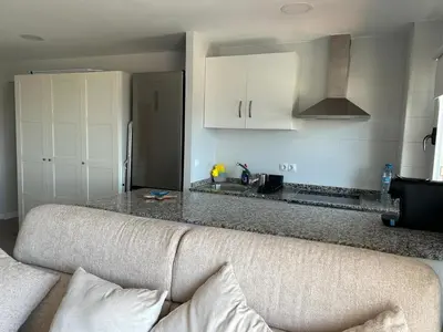 a living room with a couch and a kitchen at District Key - Valencia, Manuel Candela in Valencia