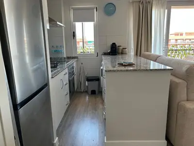 a kitchen with a refrigerator and a counter top at District Key - Valencia, Manuel Candela in Valencia
