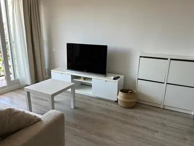 a living room with a flat screen tv on a table at District Key - Valencia, Manuel Candela in Valencia